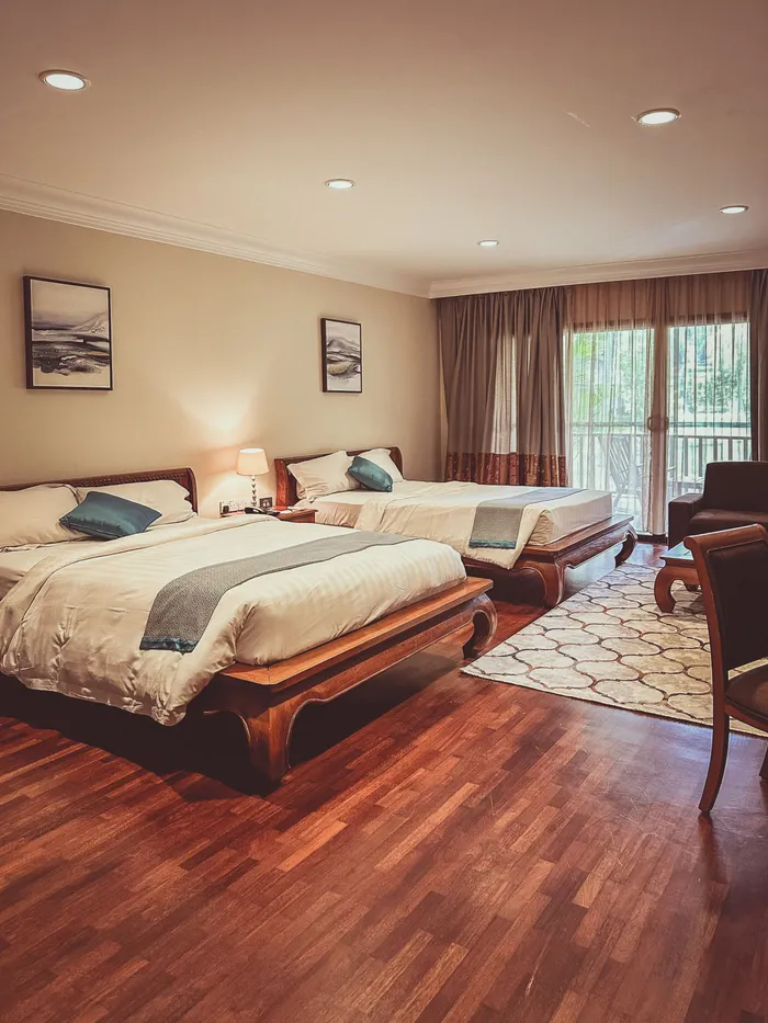 A four-bed family suite with two large beds and a balcony door